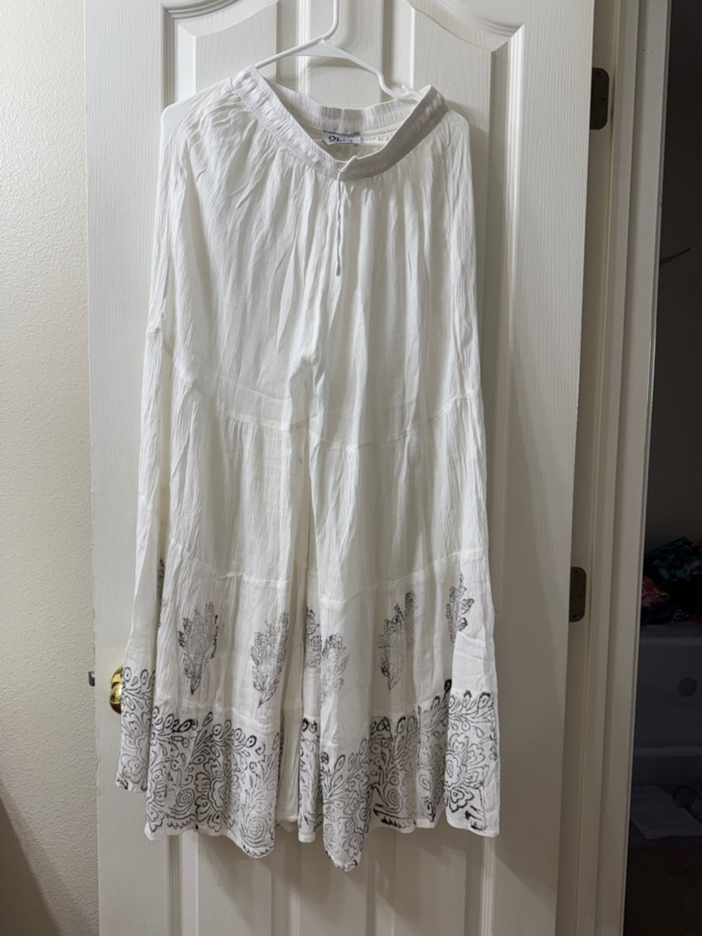 Rhea Bohemian White flowy boho pants with prints along the hem